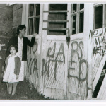 Nagaishi family standing outside garage with graffiti