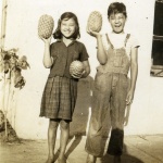Two children holding pineapples