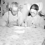 Japanese Americans preparing shells for jewelry making