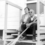 Issei couple sitting on barracks porch