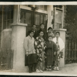 Group photograph in front of house