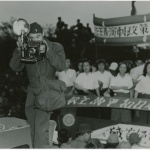 Ted Akimoto taking a photograph