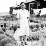 Japanese American in front of barracks