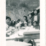 Group of women and children sitting at outdoor table